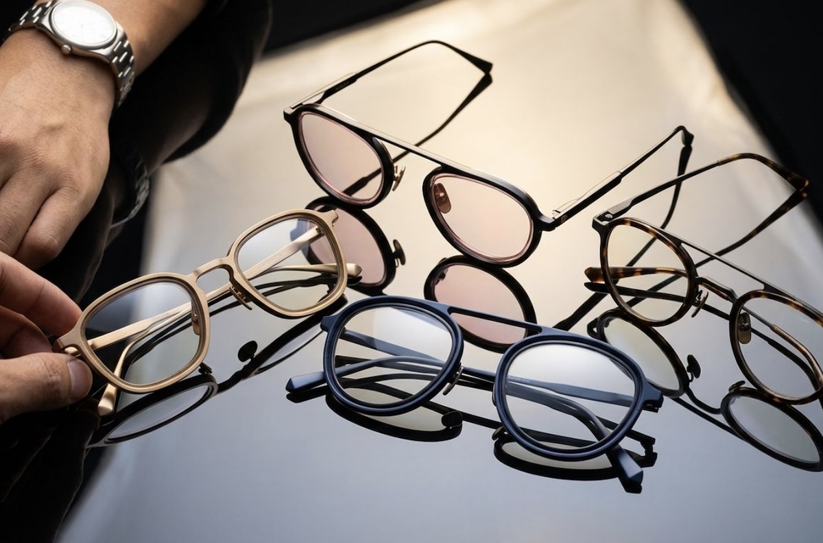 Press eyewear frame options laying on a reflective surface.